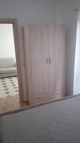 a room with a white cabinet and a mirror at Sibari Residence in Marina di Sibari