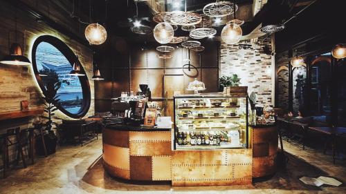a restaurant with a counter with a lot of food at Wheeler Bed &Bike in Bangsaen
