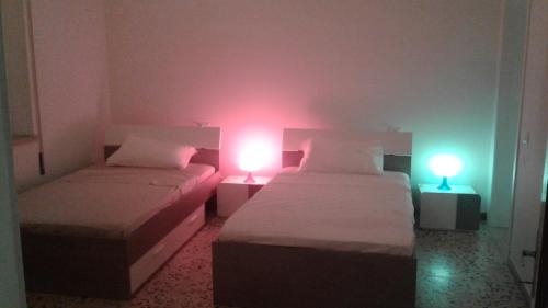 a room with two beds with lights on them at NOEMI & JULIENNE in Spineda