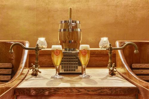 three glasses of beer on a table with abeerurrection at Kyjovský pivovar - hotel, restaurace, pivní lázně in Kyjov