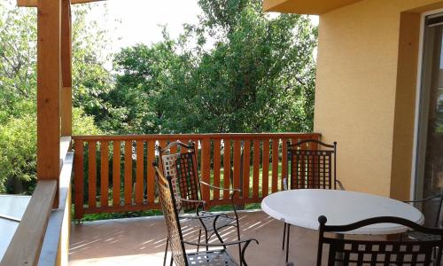 a patio with a table and chairs on a porch at Zdeňka - apartmán in Vracov