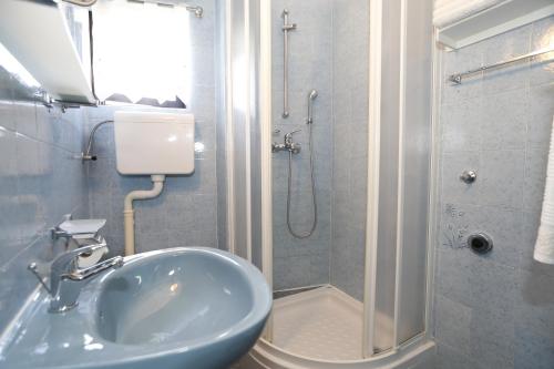 a bathroom with a sink and a shower at Apartment Luiza with Terrace in Baška