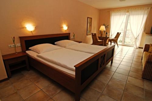 a bedroom with a large bed in a room at Landhaus Kuntz in Lieser