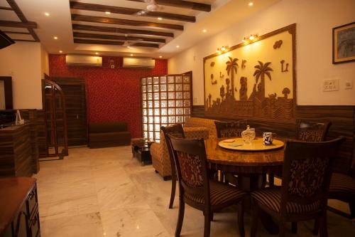 a dining room with a table and chairs at Om Sai Villa Guesthouse in Kolkata