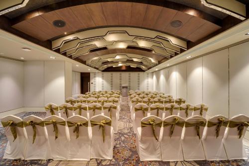 a room with a row of chairs in a hall at Novotel Kochi Infopark in Cochin