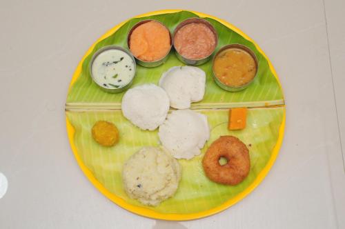 a plate of food with different types of food on it at Hotel New Amirtham inn in Palani