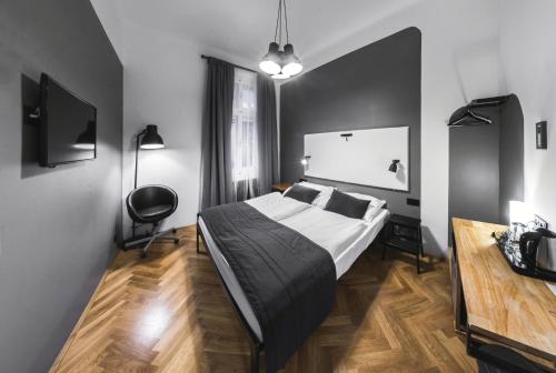 a bedroom with a bed and a desk in it at Czech Inn in Prague