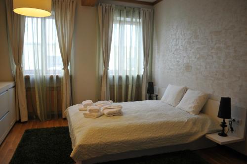 a bedroom with a bed with towels on it at Luxury Apartment in Braşov