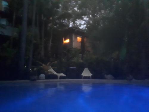 a night view of a swimming pool at night at Alaya Ascend in Eudlo