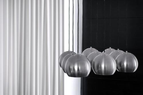 a row of silver lights hanging from a wall at Bab Hotel in Marrakech