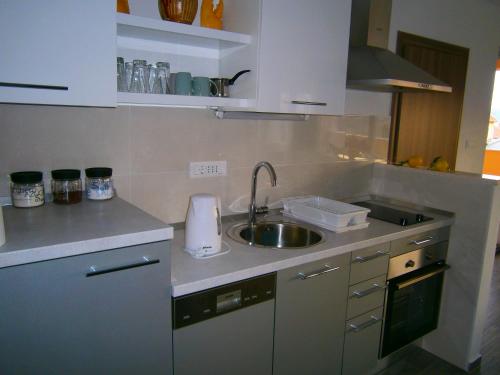 a small kitchen with a sink and a counter top at Studio apartment Luzia in Komiža