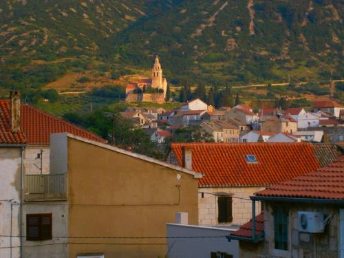 a town with a castle on a hill with buildings at Studio apartment Luzia in Komiža