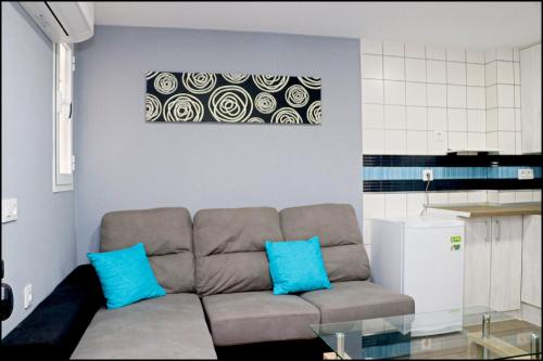 コニル・デ・ラ・フロンテーラにあるApartamento Baluarteのリビングルーム(青い枕のソファ付)