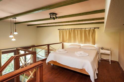 a bedroom with a bed with two towels on it at Filio House in Stalos