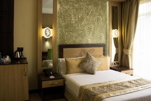 Tempat tidur dalam kamar di Elysian Resort