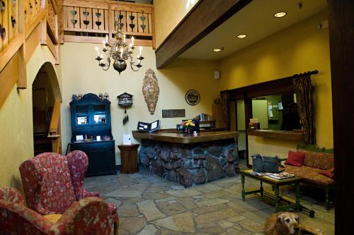 a living room with a bar and a dog in it at The Alpenhof in Teton Village