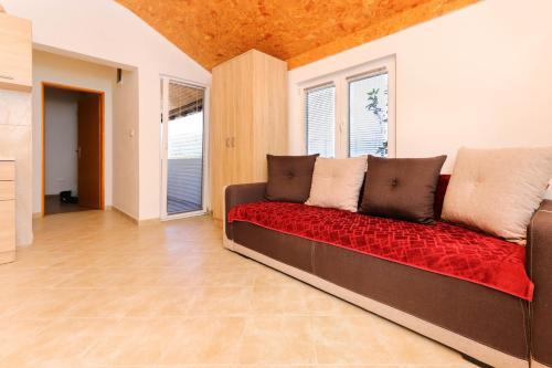 a living room with a couch and a window at Apartment Sea Star in Tivat