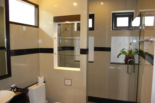 a bathroom with a shower and a toilet and a sink at Leelawadee Garden Resort in Ao Nam Mao