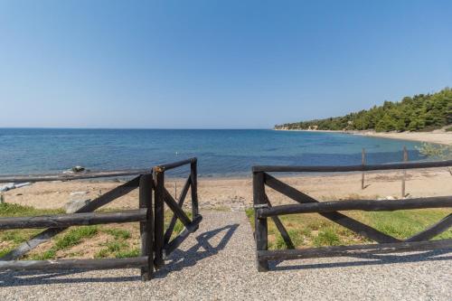 a wooden gate on the side of a beach at Alexger Psakoudia Seaview House in Psakoudia
