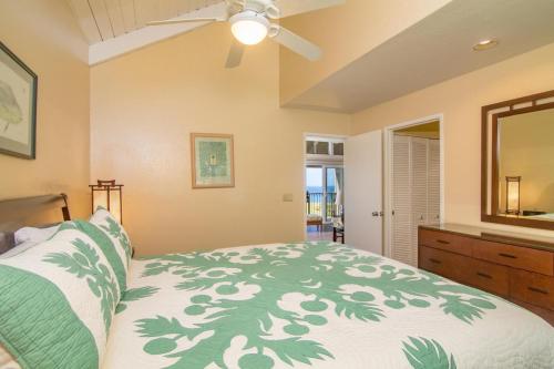 a bedroom with a bed and a ceiling fan at Pali Ke Kua #241 in Princeville