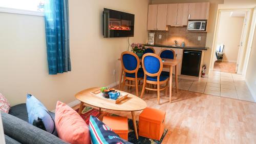 a living room with a couch and a table and a kitchen at Valencia Suite - 2 Bedroom basement in Jasper