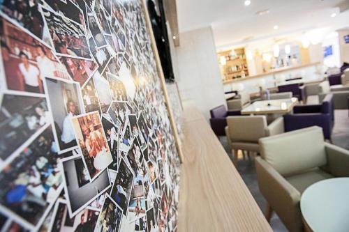 a restaurant with a wall of pictures on the wall at Hotel Morlans in Paguera