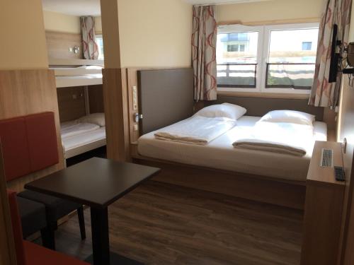 a small room with a bed and a window at Schwedenhaus Wismar in Wismar