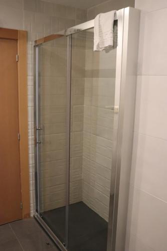 a shower with a glass door in a bathroom at Hotel Acosta Ciudad de la Música in Villafranca de los Barros