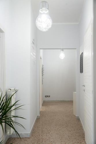 an empty hallway with white walls and a light fixture at Enjoy Porta Furba in Rome