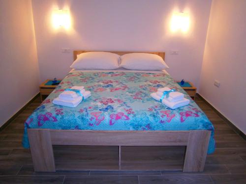 a bedroom with a bed with towels on it at Room Vilma in Komiža