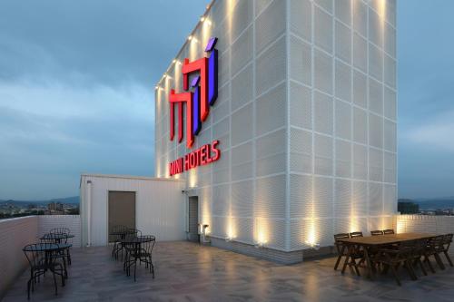 a group of tables and chairs on a building at MINI HOTELS (Taichung Station Branch) in Taichung