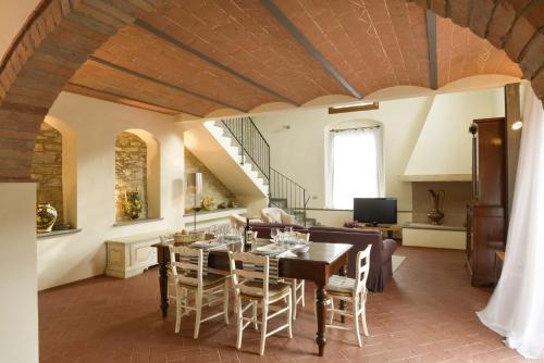 a dining room with a table and chairs at Casalta Di Pesa in Siena