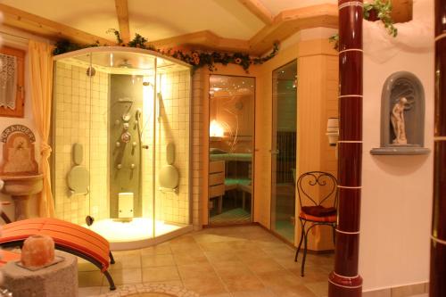 a bathroom with a shower with a glass door at Appartements Familie Eberharter in Finkenberg