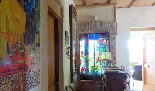 a hallway with colorful paintings on the walls at Pontet-Fronzèle agrotourisme ecologique, maison d'hôtes & Spa in Lagorce