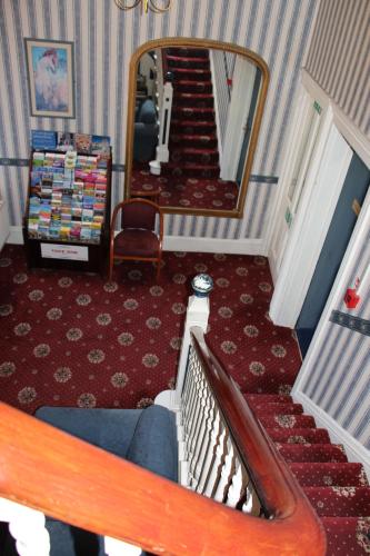 a stairway with a mirror and a stair case at Russell Hotel in Royal Tunbridge Wells