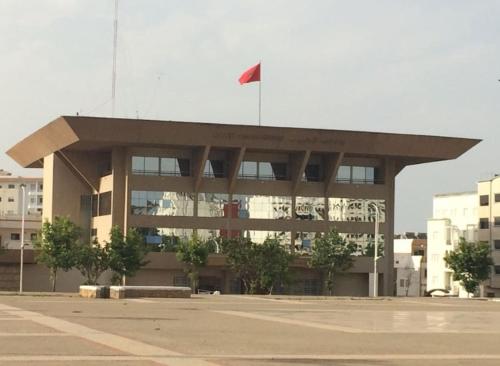 a building with a red flag on top of it at Appartement De Luxe A Wilaya De Tetouan in Tetouan