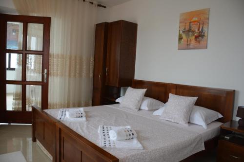 a bedroom with a bed with two towels on it at Villa Marinero in Ulcinj