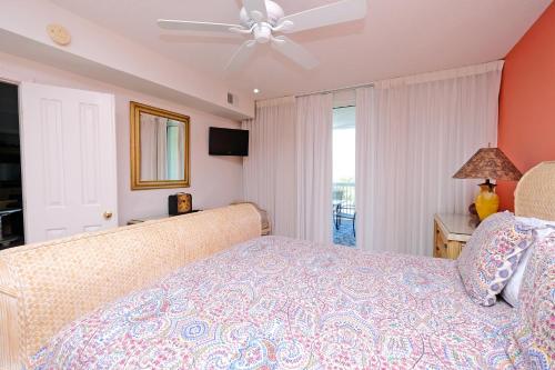 a bedroom with a bed and a ceiling fan at Litchfield Beach & Golf Resort in Pawleys Island