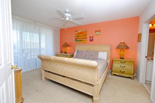 a bedroom with a bed and a ceiling fan at Litchfield Beach & Golf Resort in Pawleys Island