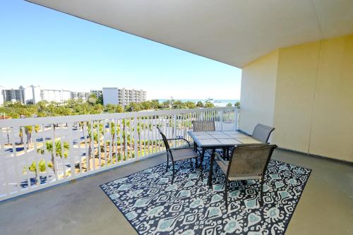 a balcony with a table and chairs on a balcony at Litchfield Beach & Golf Resort in Pawleys Island