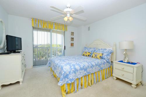 a bedroom with a bed and a ceiling fan at Litchfield Beach & Golf Resort in Pawleys Island
