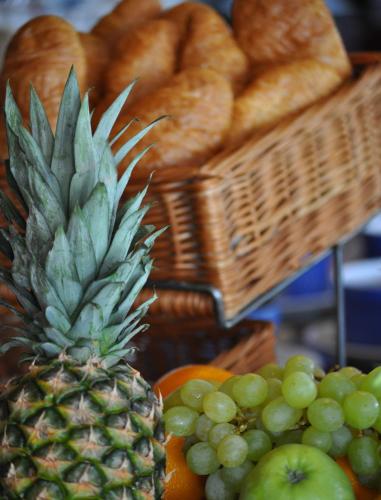 a pineapple sitting next to a bunch of bread at Best Western Royal Star in Stockholm
