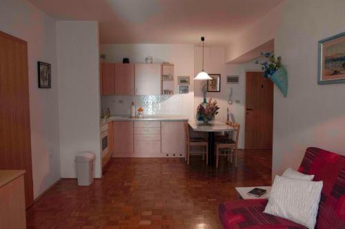 a kitchen with a table and a dining room at Spacious balcony apartment Piran in Piran