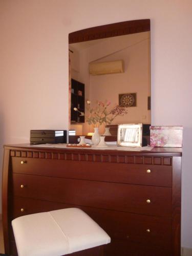 a dresser with a mirror on top of it at Dream House in Iraklitsa