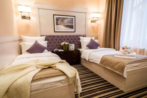 a hotel room with two beds and a window at Park Hotel Warshawskiy in Sarny