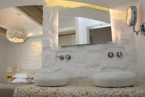 a bathroom with two white sinks and a mirror at Spiros in Naxos Chora
