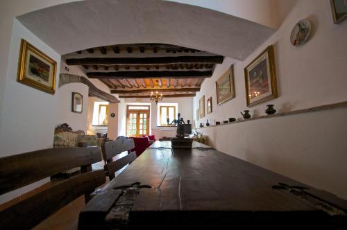 a dining room with a long table in a house at Agriturismo Corvaia in Radicofani