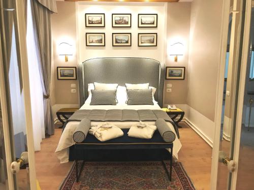 a bedroom with a large bed with two towels on it at Hotel Scapolatiello in Cava deʼ Tirreni