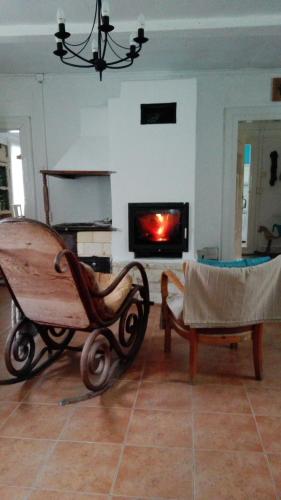a living room with a wooden wagon and a fireplace at Niebieska Chatka in Sąsiadka