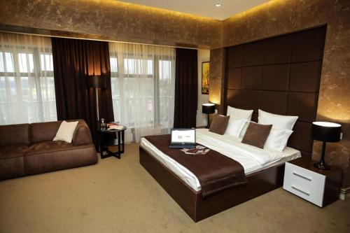 a hotel room with a bed and a laptop on it at Park Hotel Warshawskiy in Sarny